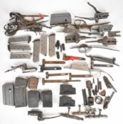 A collection of shotgun and rifle parts and accessories including magazines, locks, trigger