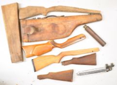 A collection of gun and shooting related items comprising leather leg of mutton case, five rifle