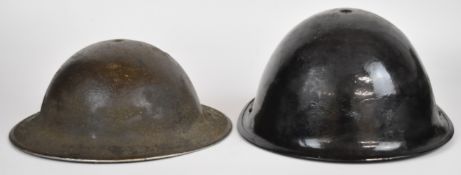 Two British military helmets, one WW2 the other circa 1960, both with information to inside of the