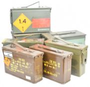 Seven metal military ammunition tins with various military markings including 7.62.