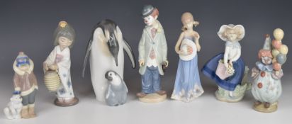 Seven Lladro figures including Emperor penguin with chick, clown, Japanese girl etc, tallest 21cm