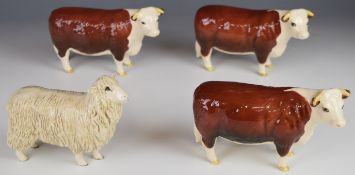 Three Beswick Hereford cow figures and a sheep, all boxed, tallest 10cm