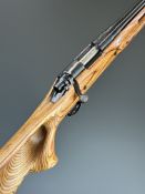 Remington Model 700 6mm bolt-action rifle with engraved action, laminate show wood stock, thumb-hole