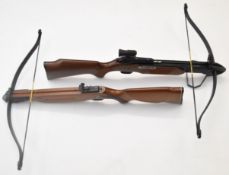 Two Barnett crossbows both with wooden stocks, one Wildcat III with peep hole sights the other