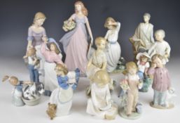 Fourteen Lladro / Nao figurines including figures with dogs, goat etc, tallest 28cm