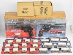 Six Daisy Model 04 airsoft revolvers and Model 38 airsoft pistols, all with accessories in