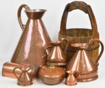 Five copper measuring jugs from 5 gallons down to ½ gill, together with two copper foot warmers