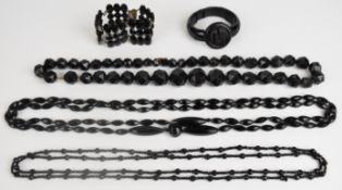 A collection of Whitby and French jet including two necklaces made up of faceted beads, carved