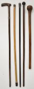 Four vintage walking sticks, three with silver mounts, and a 19thC African tribal Knobkerrie,