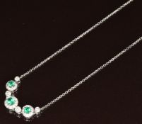 An 18ct white gold necklace set with emeralds and diamonds, the total emerald weight approximately