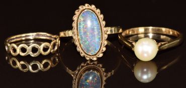 Three 9ct gold rings, one set with an opal triplet and one a pearl, the other with pierced