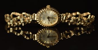 Swiss 9ct gold ladies wristwatch with gold hands and baton hour markers, silver dial and quartz
