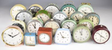 Collection of vintage alarm clocks including Smiths, Westclox, Ingersoll, Swiza, Hop, Peter, Jock,