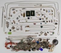 A large collection of silver chains and pendants including butterfly wing pendants, locket, moss