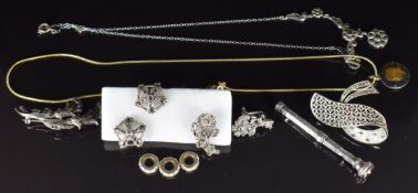 A collection of jewellery including two silver brooches, a necklace and pair of earrings set with