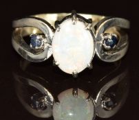 An 18ct white gold ring set with an opal and two sapphires, 3.3g, size J