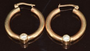 A pair of 9ct gold hoop earrings each set with a diamond of approximately 0.25ct, 11g, 2.3cm
