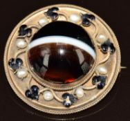 Victorian mourning brooch set with a banded agate cabochon within a border of pearls and enamel in
