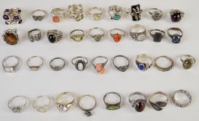 Thirty five silver rings including amethyst, opal, marcasite, moonstone, agate, etc, 138g
