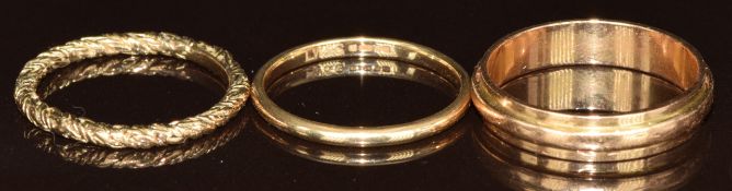 Two 9ct gold rings (3.7g, size O & P) and a yellow metal ring (4.8g, size T)