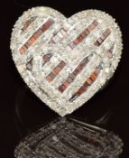 A 10k white gold ring set with red diamonds and diamonds in a heart setting, 6.1g, size N/O