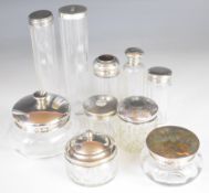 Ten various hallmarked silver lidded glass bottles and pots to include dressing table examples,