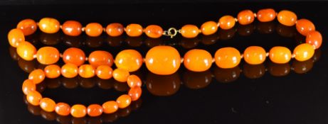 A graduated amber necklace made up of 27 graduated oval beads (49g) and matching bracelet of 16