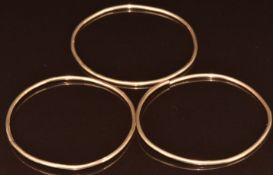 Three yellow metal bangles (test as 9k), two are cut, 25.1g