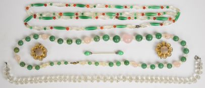 A strand of aventurine and rose quartz beads with crystal spacers, a strand of carnelian, green