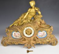 Vincenti et Cie gilt metal clock topped with a reclining lady and set with two Sèvres style