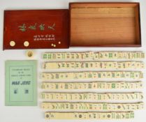 Vintage Mah Jong gaming set comprising coloured playing pieces backed in bamboo, with standard
