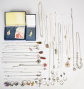 A collection of silver jewellery including amethyst brooch, twenty-one necklaces/ pendants and