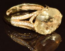 An 18k gold ring set with a chequered cut citrine and diamonds to the mount and shoulders, 6.8g,