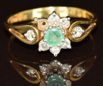 An 18ct gold ring set with an emerald and diamonds (one diamond missing), 2.4g, size O