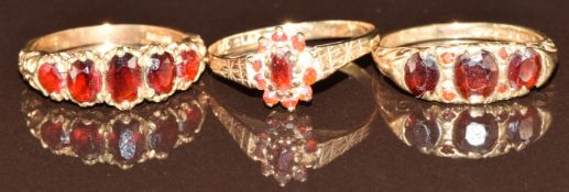 Three 9ct gold rings set with garnets, 7.3g, size N, O & P