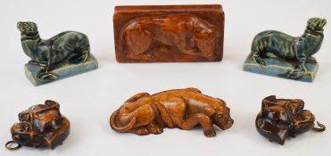 Carved wooden buckle in the form of a dog, two carved wooden treen boxes in the form of dogs and a