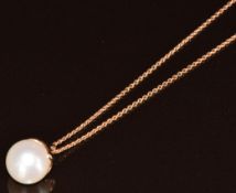 An 18ct rose gold pendant set with a pearl (10mm) by Schoeffel, on matching chain, 5.6g, 44cm (new