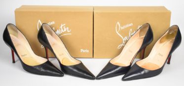 Two pairs of Christian Louboutin high heeled leather shoes, one pair black and the other navy,