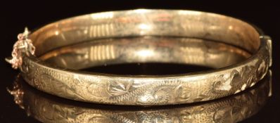 A 9ct gold bangle with engraved decoration, 10.4g, 6 x 5.5cm