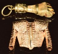 Two yellow metal charms, one in the form of a fist and the other a matador's jacket (11.3g)