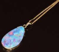 A 14k gold pendant set with a black opal doublet (3cm) on 14k gold chain, 5.1g, 41cm