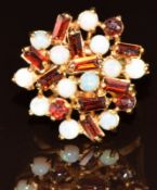 A 9ct gold ring set with garnet and opals, 5.1g, size L