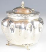 Edward VII hallmarked silver tea caddy of lobed bulbous design raised on four feet, Birmingham 1904,