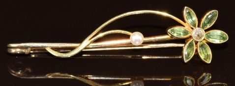 A c1915 9ct gold brooch in the form of a flower set with an old cut diamond, peridot and pearl, 2.