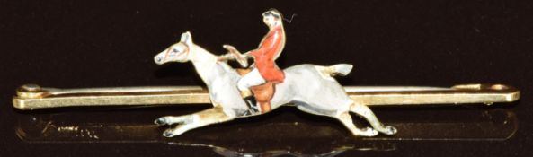 A 15ct gold brooch in the form of a man on horseback set with enamel, 3.5g, 5cm