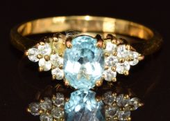 A yellow metal ring set with an oval cut topaz and paste, 2.7g, size U