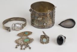 A collection of silver jewellery including bangle set with moonstones, another bangle set with
