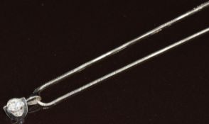 An 18k white gold pendant set with a round cut diamond of approximately 0.3ct (0.8g), on 9ct white