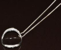 An 18ct white gold circular pendant set with diamonds (2.4cm) on an 18ct white gold chain by