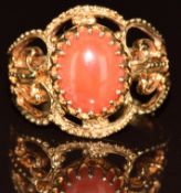 A 9ct gold ring set with a coral cabochon, 4.1g, size P